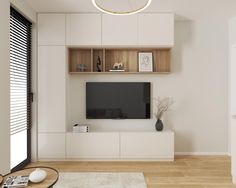 a modern living room with white walls and wooden flooring, built - in entertainment center