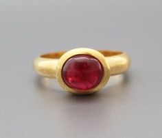 ♦♦ Beautiful handcrafted ring  ◘Stone Information:     Genuine Burmese Spinel (Natural No Heat)     Color: Red     Cut: Oval Cabochon      Size: 8 mm ◘ Metal: 925 Sterling Silver ◘ Band: 5 mm Textured ◘ Setting: Open back bezel setting ◘ Finish: Textured ◘ Nickel free  ◘ Anti tarnish ◘ Vermeil Gold(Optional) ◘ Handmade band: 14 gauge solid sterling wire    This ring is adorably rustic, easy to wear, & stackable! ◘Please Note - The Ring in the Picture can be available or  Sold out. Every  Ring is Red Domed Gemstone Rings, Domed Ruby Gemstone Jewelry, Oval Cabochon Ruby Gemstones, Ruby Jewelry With Large Round Stone, Oval Cabochon Ruby Jewelry With Bezel Setting, Round Ruby Jewelry With Large Stone, Classic Round Ruby Ring With Stone Setting, Elegant Large Stone Ruby Ring, Handmade Oval Ruby Ring In Yellow Gold