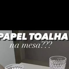 two glasses sitting on top of a table next to each other with the words papeltoalaha na mesa??