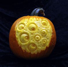 a carved pumpkin with yellow circles on it