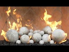 a bunch of balls sitting in front of a fire