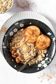 a bowl filled with oatmeal and sliced almonds