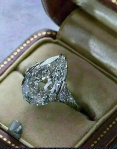 an oval cut diamond ring in a box