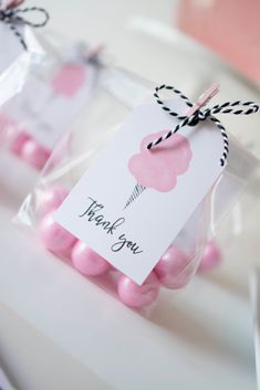 two bags with pink candies in them and a thank you tag on the top