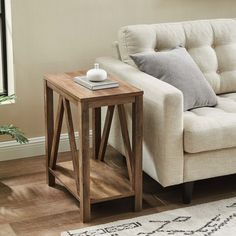 a white couch sitting next to a wooden table