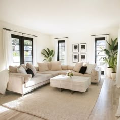 a living room filled with furniture and lots of windows