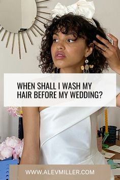 a woman in a white dress holding her hair with the words when shall i wash my hair before my wedding?