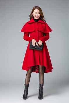 "Chic and classic, this woman's red wool cape coat features a beautiful pleated skirt with drop hem in front, making it ultra feminine. The romantic coat designed with a removable capelet, it will keep you warm in the winter. Details: * 50% wool blend fabric * Polyester lining * long sleeves * two side pockets * buttons fasten front * with a cape can be moved off * high low hem * lapel collar SIZE GUIDE Size vary between Brand and Country Please get your body measurement with our Size Guide And Womens Cape Coat, Capelet Coat, High Low Coat, Fit And Flare Coat, Wool Cape Coat, Wool Winter Coat, Black Wool Coat, Outwear Coat, Wool Cape