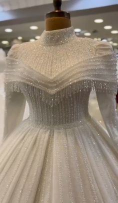 a white wedding dress on display in a store