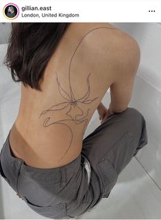 the back of a woman's body with an outline of a bird on it