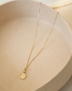 Arriya - a luminous strand of pure gold, this adjustable cable chain embodies delicate elegance. Its fine craftsmanship whispers sophistication, making it the ideal complement to our Mini Disc charm, whose textured surface dances with light at every turn. Personalize your necklace further by adding an array of charms, making Arriya uniquely yours. Delicate Charm Necklace With Oval Pendant And Adjustable Chain, Delicate Charm Necklace With Oval Pendant, Elegant Charm Necklace With Delicate Chain In Recycled Gold, Timeless Charm Necklace With Delicate Chain And Round Pendant, Elegant Charm Necklaces With Delicate Chain In Recycled Gold, Adjustable Yellow Gold Delicate Charm Necklace, Elegant Recycled Gold Charm Necklace With Delicate Chain, Timeless Cable Chain Charm Necklace As Gift, Timeless Cable Chain Charm Necklace For Gift