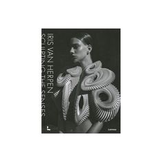 a black and white photo of a woman with spirals on her shoulders, in front of a dark background