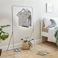 an ironing board with clothes hanging on it