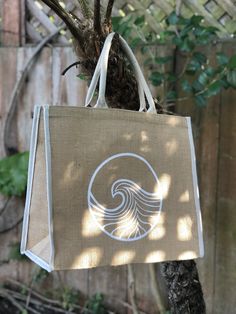 Large jute tote bag with hand painted wave design in white and natural woven handles and edge detailing. Small velcro patch to keep it closed. Perfect beach tote, for grocery shopping, or day trips. Eco-friendly Cream Beach Bag, White Jute Beach Bag For Everyday Use, White Jute Beach Bag For Daily Use, White Rectangular Jute Beach Bag, Eco-friendly White Tote Beach Bag, Eco-friendly White Jute Beach Bag, Handmade White Eco-friendly Canvas Bag, Eco-friendly White Canvas Beach Bag, Eco-friendly Handmade White Canvas Bag