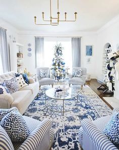 a living room filled with furniture and a christmas tree