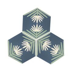 three hexagonal tiles with white and green leaves on them, all arranged in the same pattern