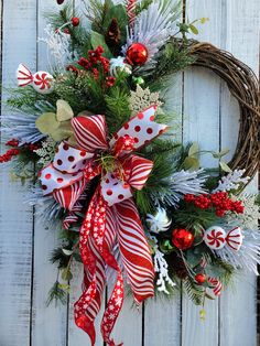 a wreath with red, white and green decorations