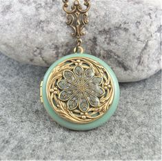 Sage green filigree locket.  Antique style flower locket pendant. Beautiful filigree handcrafted brass locket perfect gift for her. The locket measures approx 31mm and is hanging on an antiqued brass chain, please choose your length at checkout.   Inside of the locket are two spaces for photo's etc to be glued in.  The locket will arrive in a little gift box  ready for giving. Tracked shipping included for USA customers. Thanks for looking. Luxury Green Locket Necklaces, Luxury Green Locket Necklace, Wedding Locket, Victorian Style Jewelry, Enamel Locket, Silver Locket Necklace, Memory Locket, Vintage Lockets, Silver Lockets