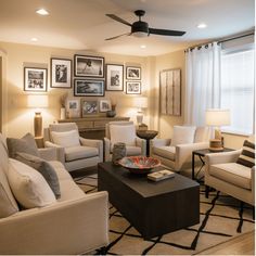 Modern living room with beige couches, black coffee table, gallery wall, and contemporary decor. Low Ceiling Basement Ideas, Ceiling Basement Ideas, Unique Lighting Ideas, Ceiling Basement, Low Ceiling Basement, Painted Ceilings, Exposed Ceilings, Basement Gym, Modern Basement