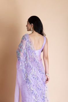 Editor's Note Featuring a lavender hand-embroidered silk organza saree. This comes with matching unstitched blouse piece in chanderi and matching underskirt fabric in shampoo. Color: Lilac Fabric: Silk Organza Length: Saree Length: 5.5m; Blouse Fabric: 1m Care: Dry Clean Only About the Designer Saksham & Neharicka make modernizing Indian wear with rich handwoven textiles, fresh intricate textures, chic and classic silhouettes, Saksham & Neharicka handcraft all designs to eternal perfection. Thei Designer Wear Pre-draped Organza Saree, Designer Organza Pre-draped Saree, Transitional Organza Saree With Unstitched Blouse, Purple Chanderi Sharara For Reception, Bollywood Style Organza Pre-draped Saree, Embroidered Purple Sharara, Organza Blouse Piece With Chikankari Embroidery For Reception, Embroidered Cotton Silk Pre-draped Saree For Party, Organza Embroidered Pre-draped Saree For Reception