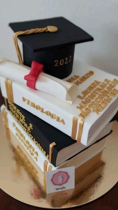 three books stacked on top of each other with graduation caps and diplomas on them