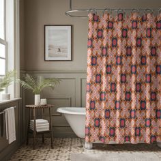 a bathroom with a bathtub, sink and shower curtain in orange and blue colors