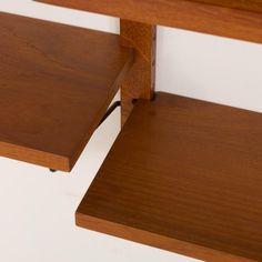 a close up of two wooden tables with one on the other side