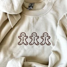 🎄 Get into the holiday spirit with our adorable Gingerbread Man embroidered sweatshirt! This cozy, festive sweatshirt is the perfect addition to your winter wardrobe, combining comfort and style for a jolly Christmas season. 🎅 🧵 Handcrafted with love, this sweatshirt features a beautifully detailed Gingerbread Man embroidery that adds a touch of whimsy and charm to your look. The high-quality embroidery is durable and will last for many holiday seasons to come. 🎁 It makes a fantastic gift for friends and family, or a delightful treat for yourself. Spread the Christmas cheer by wearing this sweatshirt to family gatherings, festive parties, or simply while sipping hot cocoa by the fireplace. ✨ Product Details: Available in multiple sizes for a comfortable fit. Soft and warm, perfect for Christmas Sweatshirt Ideas, Man Embroidery, Sweater Designs, Sweatshirt Ideas, Cozy Wear, Mom Fashion, Cozy Holiday, Jolly Christmas