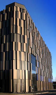 a tall building with lots of windows on top of it's face and side