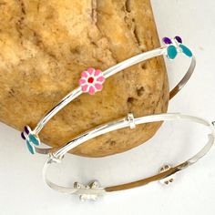 Handmade 925 Sterling Silver Adjustable Baby Bangle With Butterfly-Flower Enamel . Adjustable Baby Bangle Bracelet. Sterling Silver Baby Girl Jewelry ------------------------------------- Details: 6 inch adjustable baby bangle bracelet. 4.4 gram. Please measure the wrist size of your baby/toddler with a thread. There could be a fluctuation in the Dimensions. ------------------------------------- Do Visit our Shop for more jewelry: https://www.etsy.com/shop/InsiaJewelry -------------------------- Adjustable Stamped 925 Jewelry For Birthday, Playful Sterling Silver Jewelry For Birthday, Playful Silver Jewelry For Birthdays, Playful Silver Jewelry For Birthday, Playful Handmade Silver Jewelry, Playful Silver Bracelets For Gifts, Playful Handmade Silver Bracelets, Playful Adjustable Silver Bracelets, Adjustable Sterling Silver Bracelet For Birthday