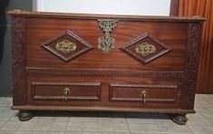 an old wooden dresser with ornate carvings on it