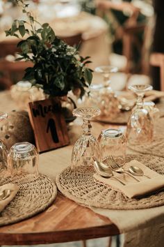 the table is set with silverware and place settings