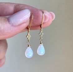 Rainbow Moonstone Earrings, Teardrop Dangle Earrings, Minimalist Gold Earrings, June Birthstone, Small Moonstone Earrings, Gift for women These precious delicate earrings feature blue flash rainbow moonstone smooth teardrops adorned with a white topaz connector in either gold or silver finish. The earrings are suspended from lever back ear wires in gold filled or sterling silver. These earrings are very feminine and subtle, perfect for every day and the moonstone makes them suitable for almost a Minimalist Gold Earrings, Bridal Party Jewelry, Minimalist Earrings Gold, Silver Gift Wrap, Freshwater Pearl Jewelry, Earrings Teardrop, Teardrop Dangle Earrings, Moonstone Earrings, June Birthstone