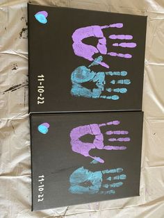 two canvases with hand prints on them