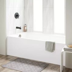 a white bath tub sitting next to a window