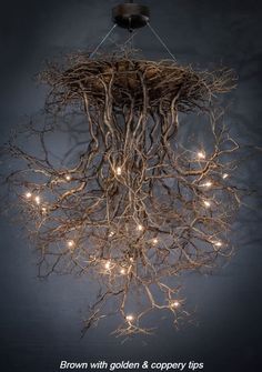 a chandelier made out of branches with lights hanging from the top and bottom