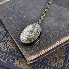 Oval vintage style locket. It is antiqued brass and the inside is quite a bit darker. On 28 inches of antiqued brass chain. Antique Finish Oval Locket Necklace In Vintage Style, Vintage Oval Pendant Locket Necklace With Antique Finish, Antique Gold Oval Pendant Locket Necklace, Handmade Vintage Oval Pendant Locket Necklace, Vintage Oval Pendant Locket Necklace For Keepsake, Handmade Vintage Oval Locket Necklace, Vintage Oval Locket Necklace For Keepsake, Bronze Oval Pendant Locket Necklace, Vintage Handmade Oval Locket Necklace