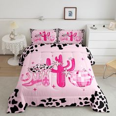 a pink and black bed with cow print on it