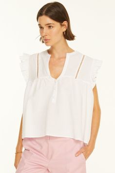 Altese Blouse is a cotton/linen blend top with the eyelet lace on the shoulders and ruffles at the sleeve opening. Relaxed Fit. Material: 80% Cotton 20% Linen. Model wears size 'S'. Cotton Broderie Anglaise Tops For Day Out, Summer Ruffle Sleeve Tops With Lace Trim, Summer Tops With Lace Trim And Ruffle Sleeves, Ruffle Sleeve Tops With Lace Trim For Summer, Feminine Cotton Lace Top With Ruffles, Casual Lace Top Blouse With Ruffle Sleeves, Casual Blouse With Lace Top And Ruffle Sleeves, Feminine Cotton Lace Top For Daywear, Cotton Lace Top For Daywear In Feminine Style