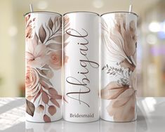 three coffee mugs with floral designs on them