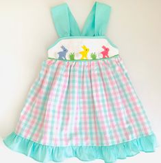 Bunny Smocked Dresses This adorable smocked dress is perfect for your little ones. They come in 5 different size (12M - 5T) and you can check the approximate measurement Washing Care Instructions Most items can be washed safely in cold water on delicate cycle and hung to dry. If the item that you are ordering has red or another bright color in it next to a white or other light color fabric please use a Shout color catcher for the first few washes to avoid bleeding. The reds are pre-washed but th Cute Gingham Smocked Dress With Ruffles, Cute Multicolor Smocked Dress With Ruffles, Playful Multicolor Smocked Dress, Cute Smocked Dress With Ruffled Straps, Multicolor Cotton Smocked Dress With Ruffles, Multicolor Dresses With Smocked Bodice And Ruffled Straps, Playful Multicolor Smocked Dress With Ruffles, Sleeveless Smocked Bodice Cute Dress, Playful Sleeveless Smocked Dress With Smocked Back