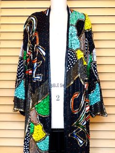 "This is a RARE and FABULOUS vintage piece embellished with bright and colorful sequins and glass beads on black silk and fully lined. There is 1 hook & eye closure at the top. It's in perfect condition! Bust - 56\" + (measured with the front brought together) Upper Arm Circumference - 29\" Top to Bottom Length - 40\" All of my items come from a smoke-free and pet-free home. If you have any questions, please don't hesitate to ask!" Multicolor Embellished Sequin Fabric For Festive Season, Multicolor Festive Sequin Fabric, Spring Bohemian Outerwear With Sequins, Multicolor Sequined Outerwear For Fall, Embellished Black Outerwear For Party Season, Black Embellished Outerwear For Party Season, Fitted Multicolor Sequined Outerwear, Spring Embellished Multicolor Sequin Fabric, Multicolor Embellished Party Outerwear