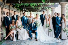 a large group of people posing for a photo in front of an outdoor gazebo