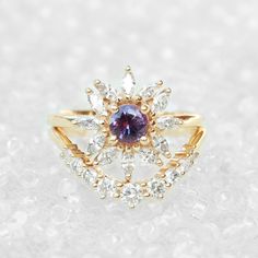 "Cluster round purple sapphire & diamonds engagement ring - Odyssey. Vintage and art deco style. Sapphire is September's birthstone. Listing is of the engagement ring alone. Ring details: ♥ Center stone: Beautiful natural round purple sapphire about 0.5ct. ♥ Side stones: Natural white diamonds, marquise cuts, about 0.60ct, F color, VS clarity. ♥ Material: 14K or 18k, yellow / white /rose solid gold. ♥ Sizes available: 4 - 11. ♥ You can request an IGL Jewelry certificate when ordering. Please Purple Diamond Ring With Halo Setting And Round Cut, Luxury Purple Sapphire Wedding Ring, Purple Sapphire Ring With Brilliant Cut, Fine Jewelry Amethyst Diamond Ring, Purple Diamond Halo Ring, Purple Tanzanite Ring With Brilliant Cut, Heirloom Purple Diamond Ring, Dazzling Tanzanite Diamond Wedding Ring, Purple Amethyst Ring With Rose Cut Diamonds For Wedding