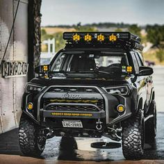 the front end of a black four - doored vehicle