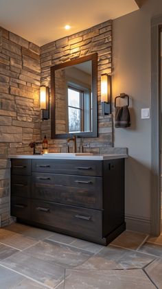 a bathroom with stone walls and a large mirror on the wall above the vanity area