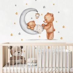 two teddy bears are on the moon wall sticker in this baby's room