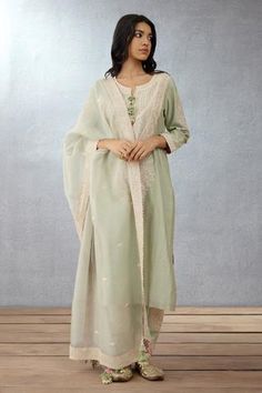 Sage green kurta with dori embroidery and shell tassel. Paired with embroidered salwar and embroidered dupatta.
Component: 3
Pattern: Embroidered
Type Of Work: Hand Adda and Dori Work
Neckline: Notched
Sleeve Type: Long Sleeves
Fabric: Kurta: Handwoven Chanderi, Cotton Voile; Salwar: Handwoven Chanderi; Dupatta: Silk Organza
Color: Green
Other Details: 
Tassel detail
Embroidered dupatta
Occasion: Destination Wedding, Wedding - Aza Fashions Organza Kurta Set, Organza Kurta, Organza Embroidery, Organza Suits, Kurta Set For Women, Kurta Designs Women, Boutique Dress Designs, Indian Suits, How To Hem Pants