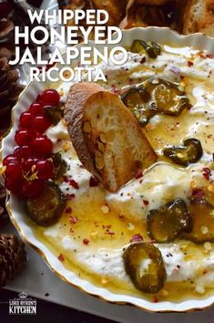 a white plate topped with bread and cheese covered in jalapeno pickles