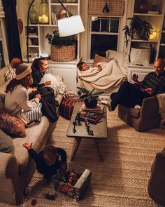 several people sitting on couches in a living room